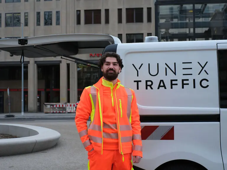 Person with a yunex car behind
